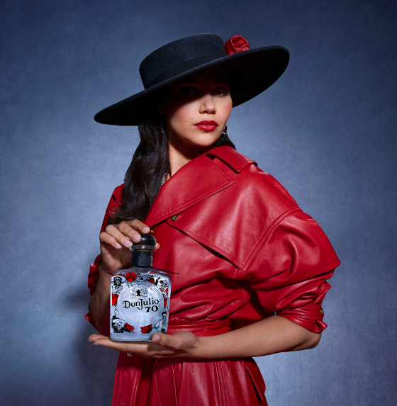 Woman in red coat holding Tequila Don Julio 70 Añejo Cristalino Willy Chavarria Artist Edition bottle