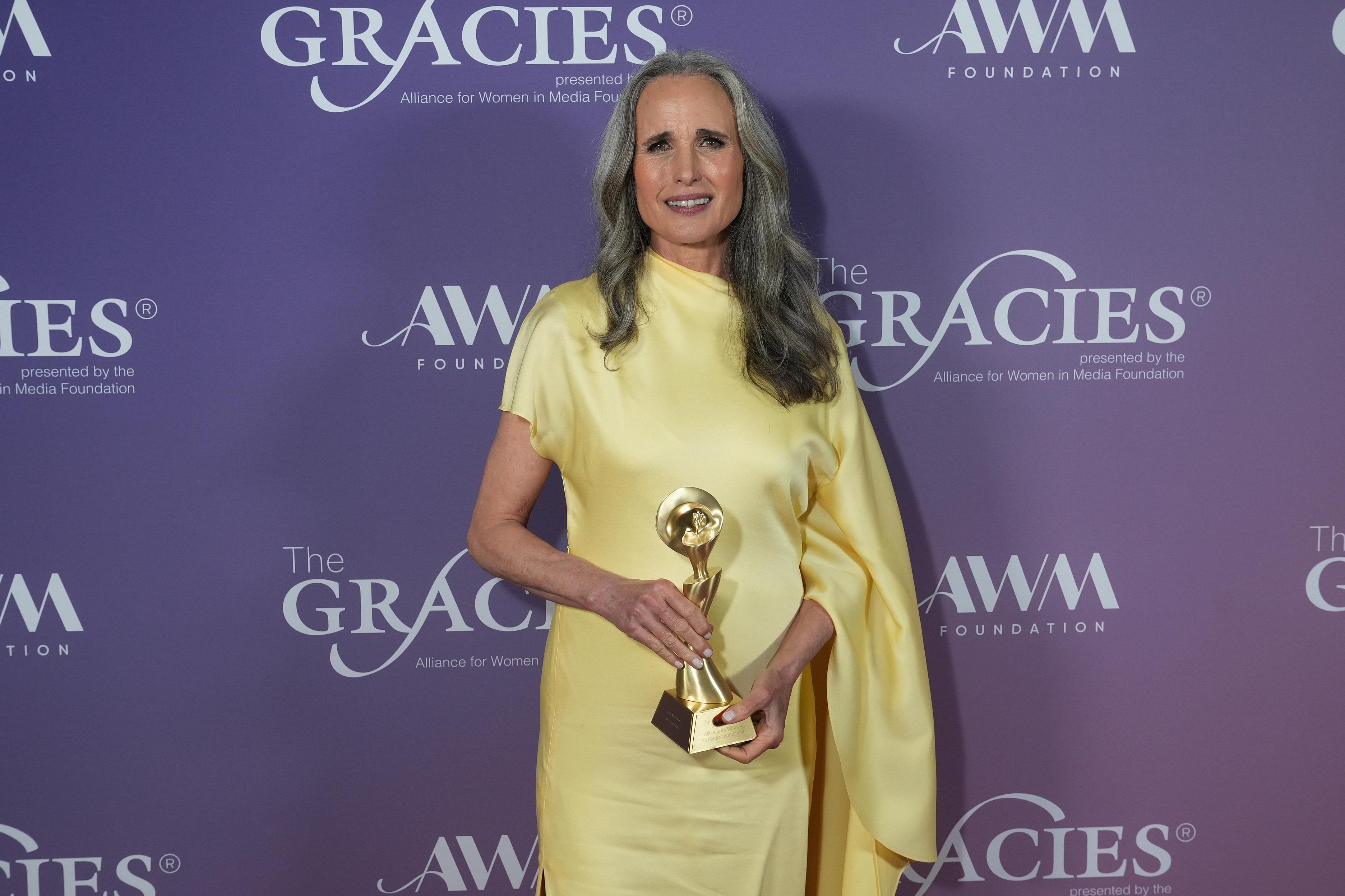 Andie MacDowell holding the Gracies Icon Award at the 51st Annual Gracie Awards in Beverly Hills