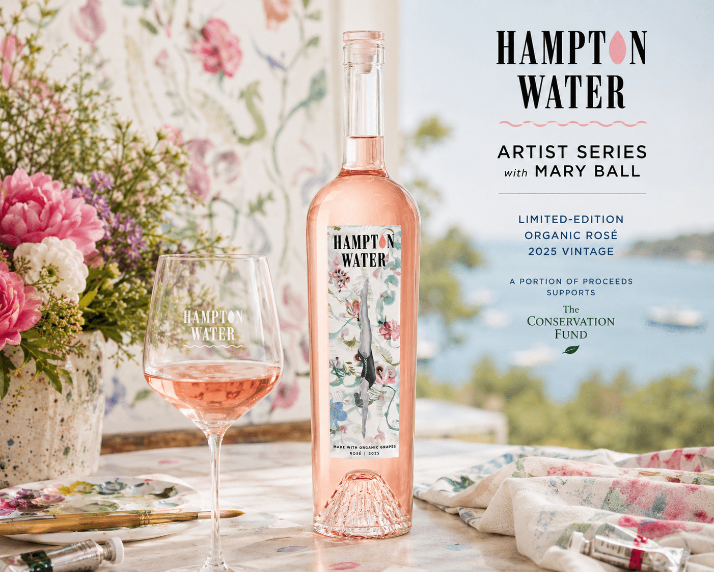 Hampton Water Artist Series rosé bottle featuring Mary Ball floral watercolor artwork beside contemporary paintings