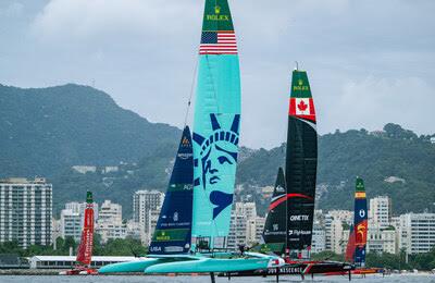 High-speed SailGP catamarans racing in New York Harbor during the New York Sail Grand Prix.