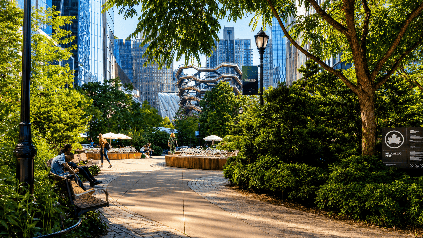Tree-lined walkway at Bella Abzug Park in Hudson Yards with The Vessel visible in the background during the 2026 season of free public programming.