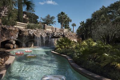 Lazy river and tropical water park landscape at Four Seasons Resort Orlando featuring waterfalls and luxury resort amenities.