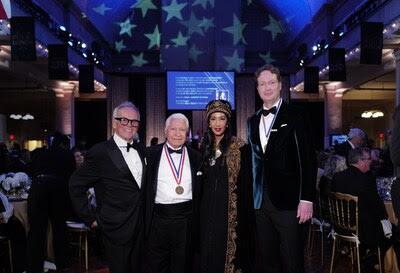 The Ellis Island Honors Society presented the Annual Ellis Island Medals of Honor, to 76 honorees. Pictured (from left to right) are celebrity chef Wolfgang Puck; Ellis Island Honors Society Chairman Nasser J. Kazeminy; fashion designer and philanthropist Gelila Assefa Puck; and CEO of Mercedes-Benz Group AG, Ola Källenius. The medal ceremony took place during a black-tie gala held in Ellis Island's Great Hall, which served as the gateway for 12 million immigrants to the U.S. The Ellis Island Medals of Honor ranks among the nation's most renowned awards. The U.S. Senate and House of Representatives have officially recognized the Ellis Island Medals of Honor, and each year the recipients are listed in the Congressional Record. (Ben Hider/AP)