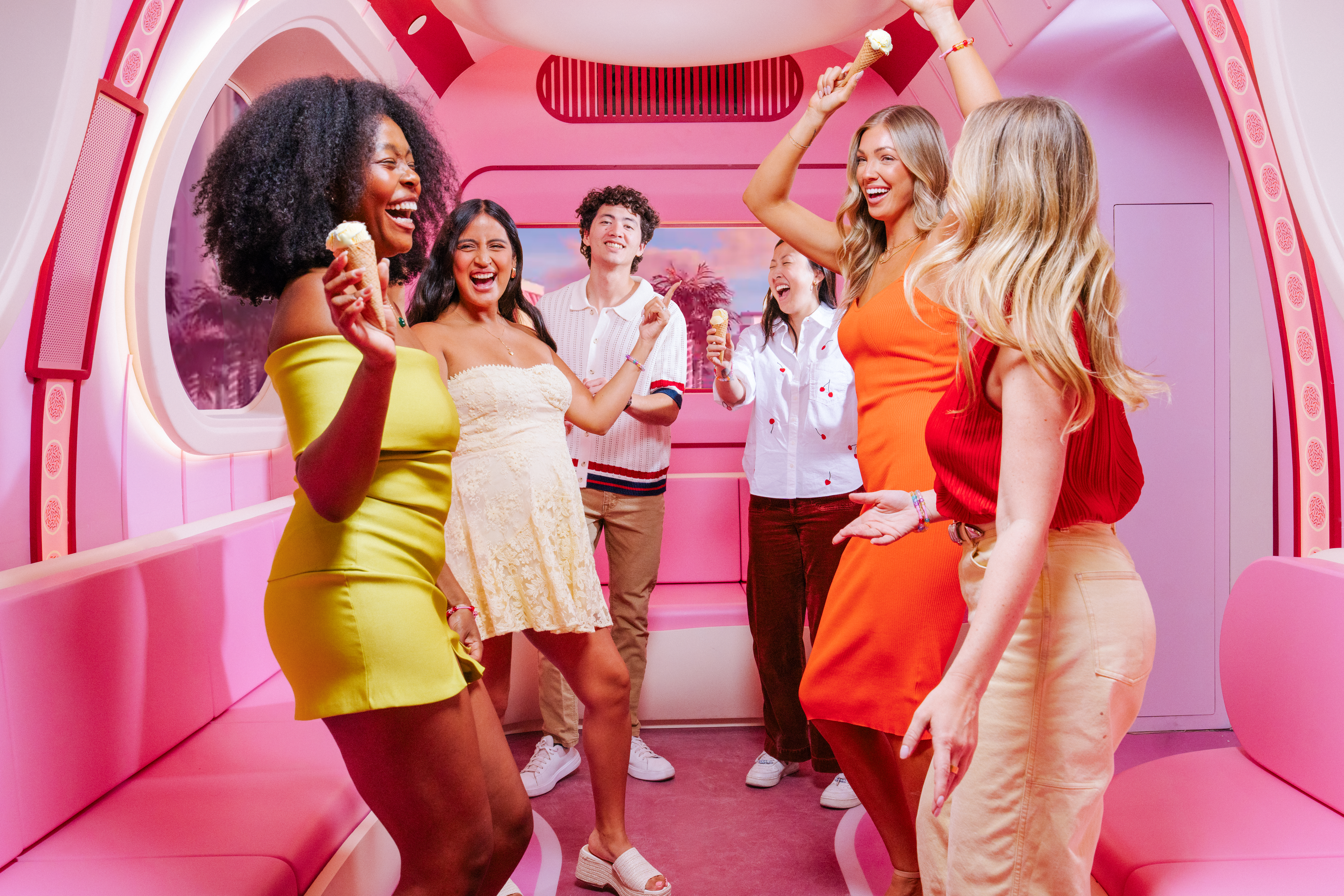 Guests enjoying ice cream inside a pink immersive Museum of Ice Cream Las Vegas installation