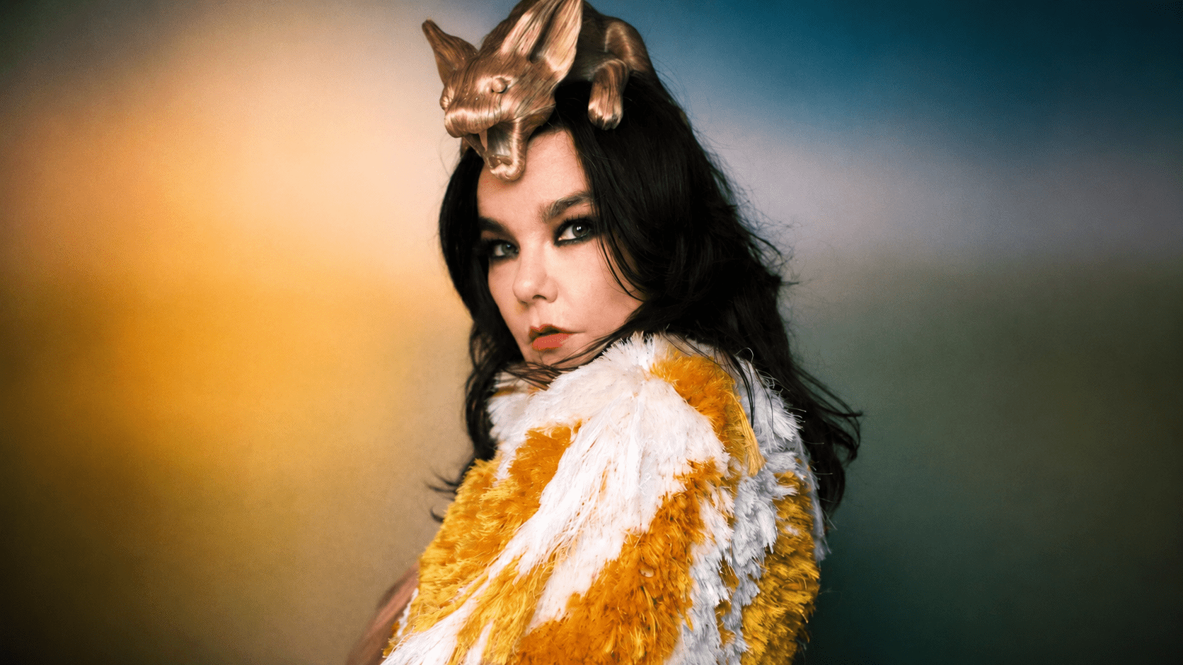 Björk wearing a textured gold and white fashion look for her major Iceland exhibition