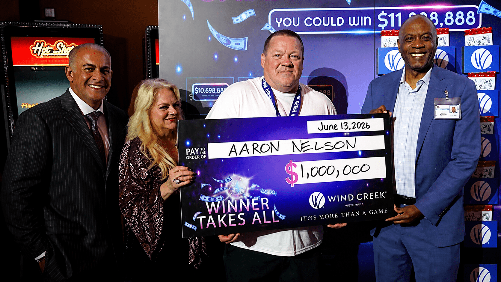 Aaron Nelson celebrates winning the Wind Creek Winner Takes All casino promotion with a $1 million prize check.