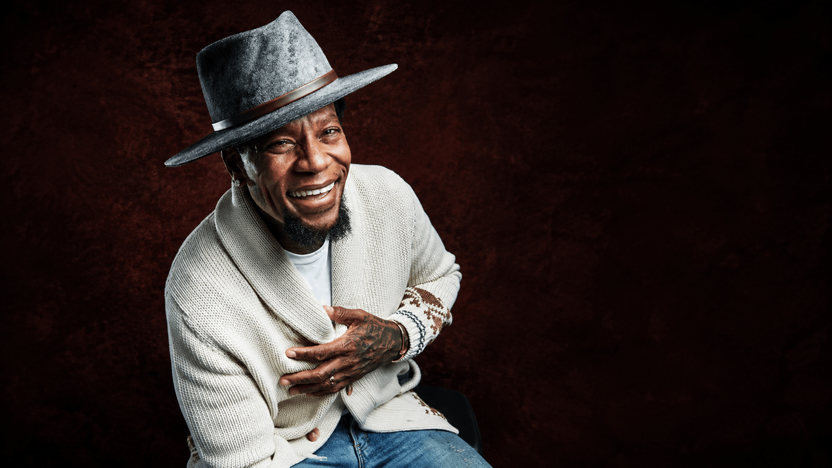 D.L. Hughley smiling in a hat ahead of his live comedy show at Rivers Casino Philadelphia